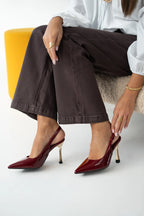 Women's patent stiletto heels with open heel, pointed toe, and gold heel