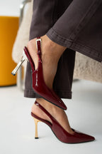 Women's patent stiletto heels with open heel, pointed toe, and gold heel