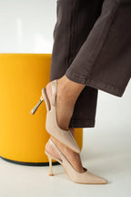 Women's patent stiletto heels with open heel, pointed toe, and gold heel