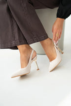 Women's patent stiletto heels with open heel, pointed toe, and gold heel