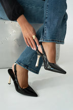 Women's patent stiletto heels with open heel, pointed toe, and gold heel