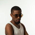 Unisex sunglasses with round brown lenses and an olive frame