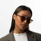 Unisex sunglasses with round brown lenses and an olive frame