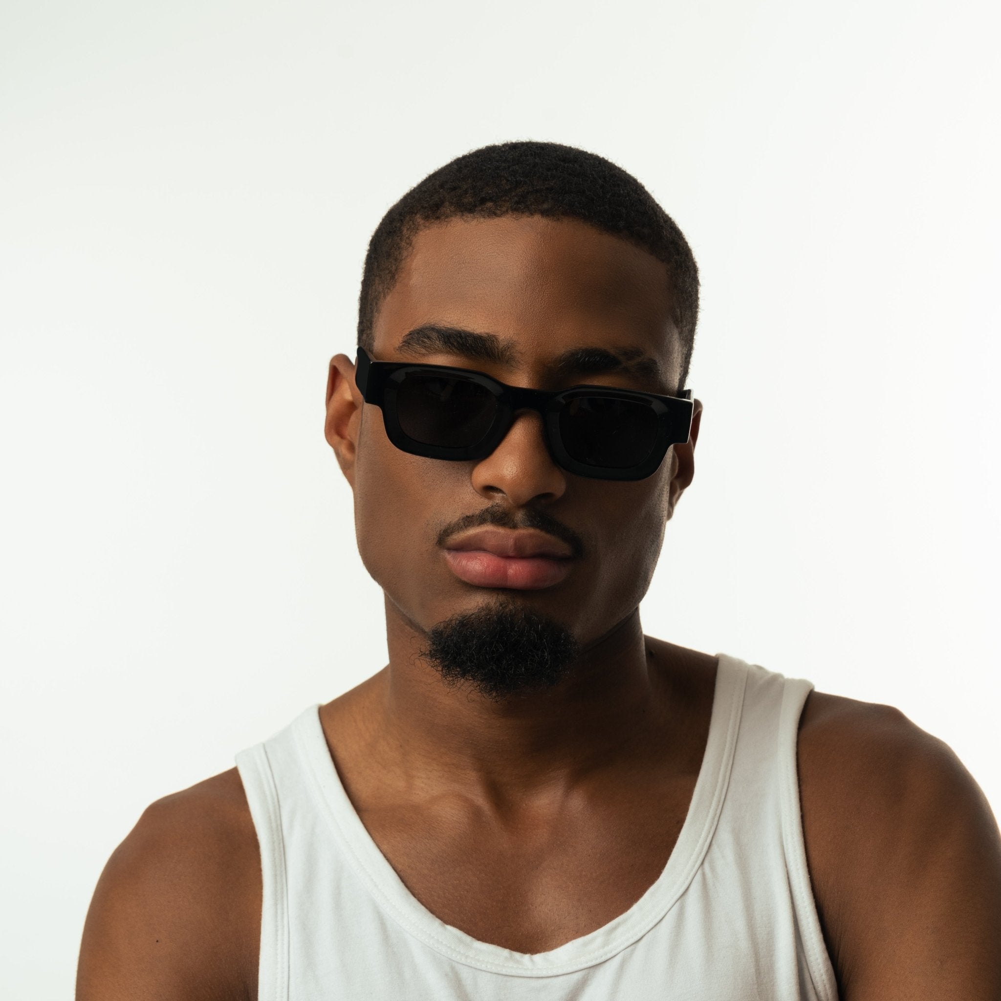 Unisex sunglasses with a rectangular frame and black lenses