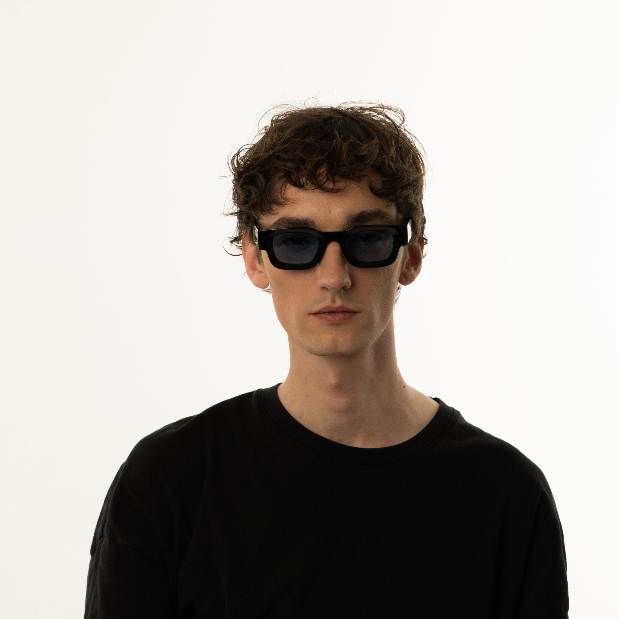 Unisex sunglasses with a rectangular frame and blue lenses