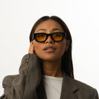 Unisex sunglasses with a rectangular frame and yellow lenses