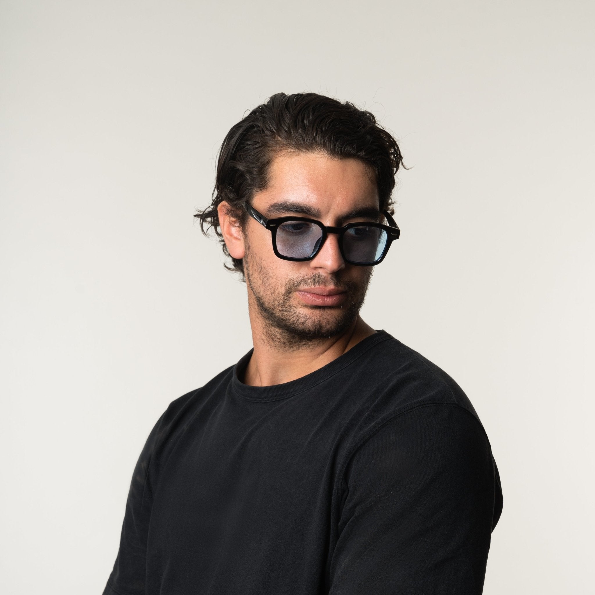 Unisex sunglasses with a wide flat frame and blue lenses